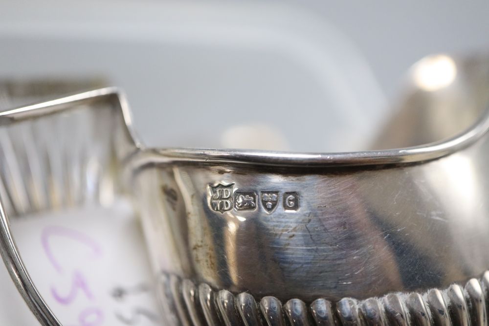 A Victorian silver mounted cut glass toilet jar, of rectangular form, with hinged lid, 9.75cm, a later lidded jar, 8cm and a cream jug